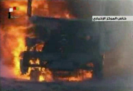 Một chiếc xe tải chìm trong biển lửa do vụ đánh bom.
